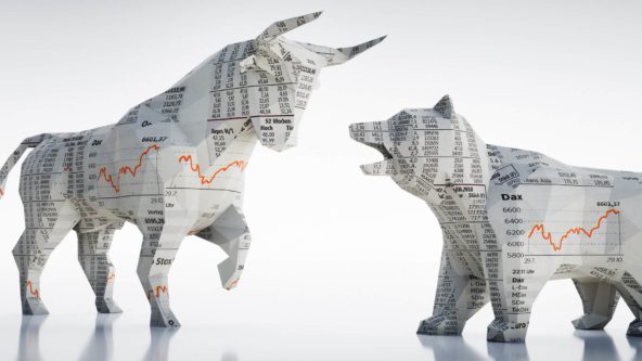 Bull and bear made out of paper with numbers and graphs on